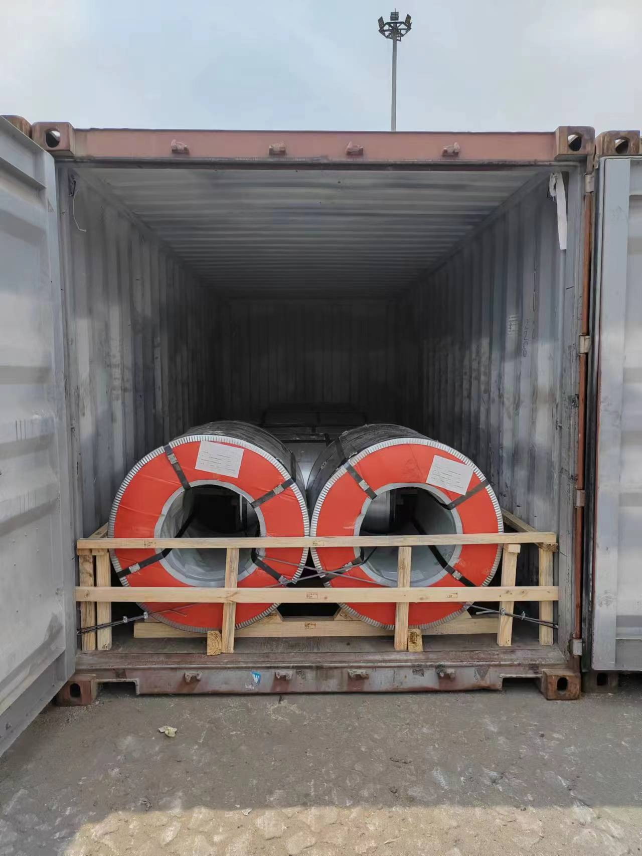 Two steel coils positioned on timber dunnage inside a container